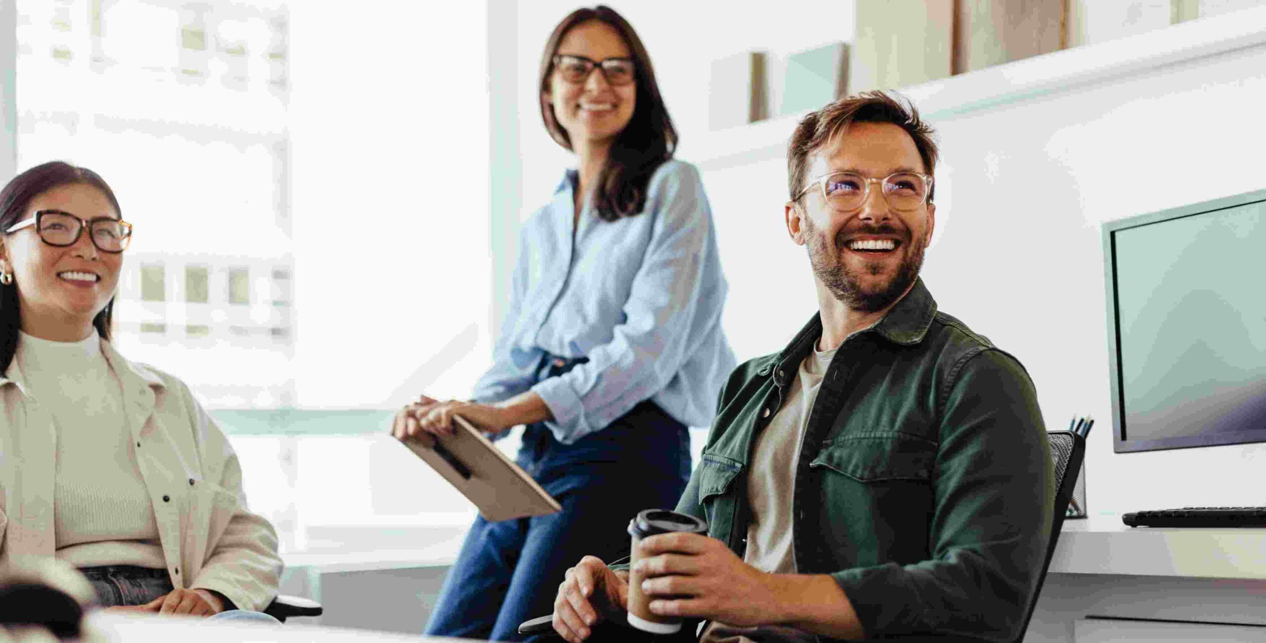 Man and woman with a consulting career interact during a team meeting.