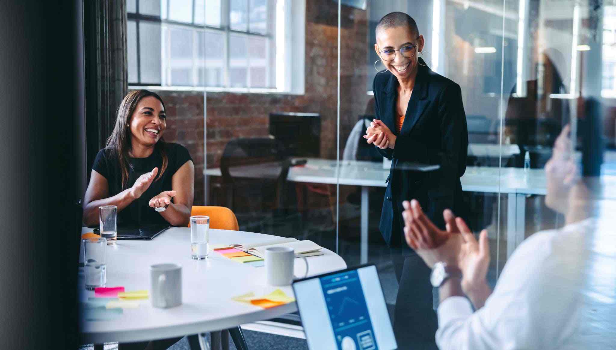 Female professionals discussing finance and accounting solutions in a meeting.