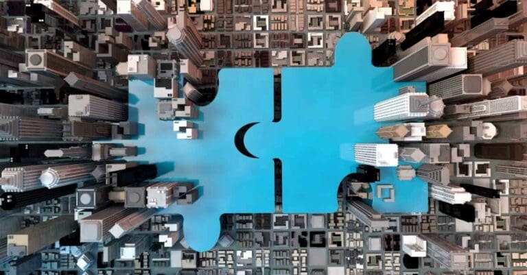 Top-down view of a city with two blue puzzle pieces coming together in the middle.