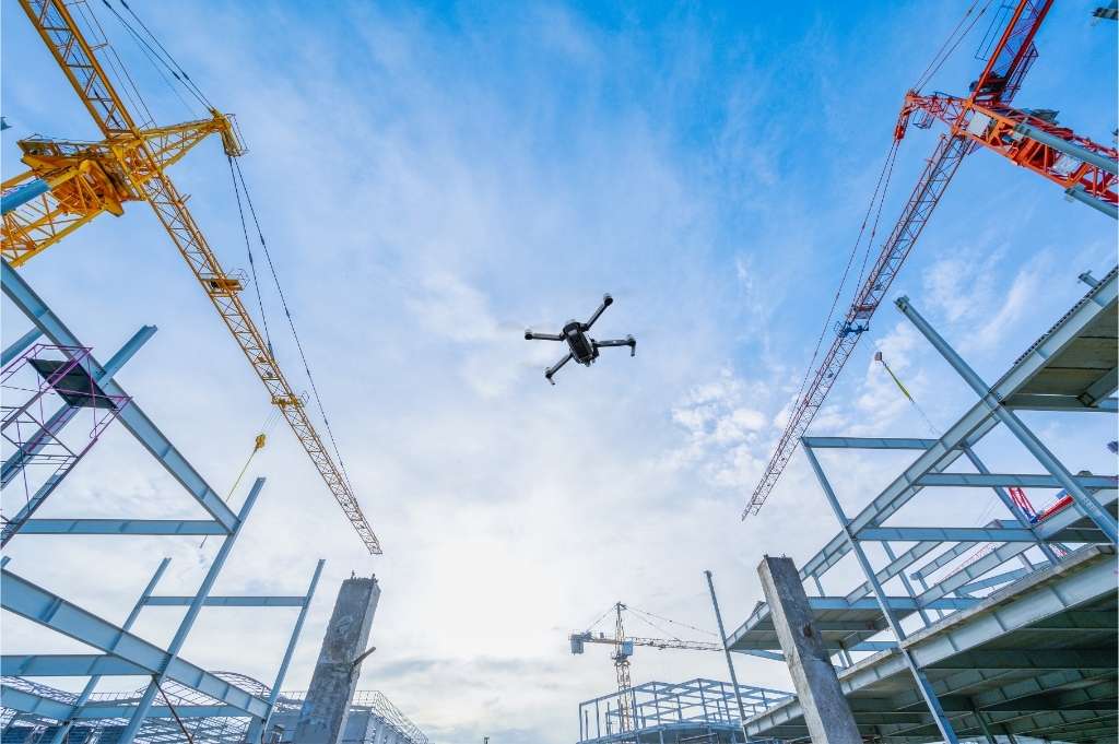Drone flying over building construction area