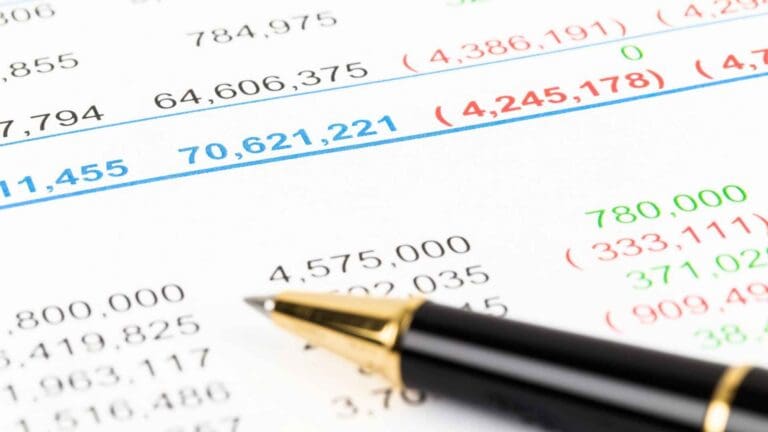 Close up of a balance sheet and a black pen on top.