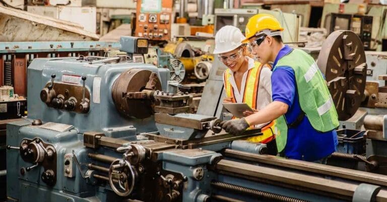 Man and women working on a manufacturing production line.