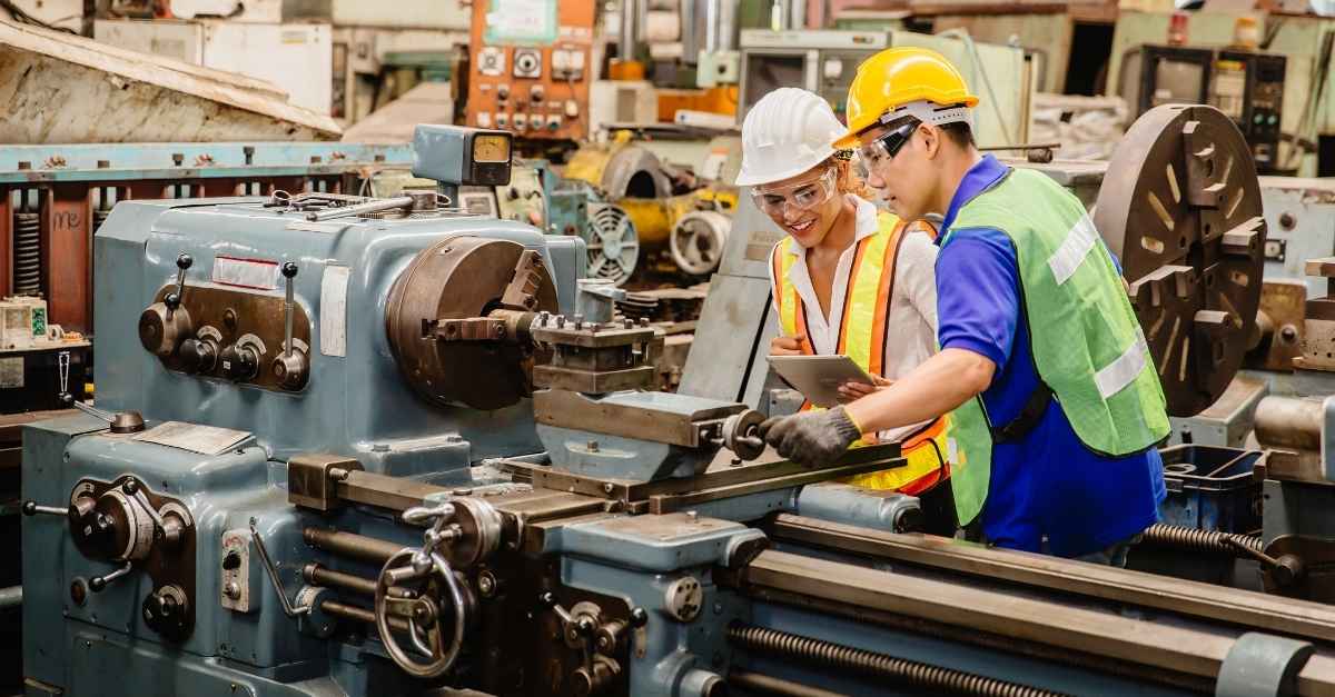 Man and women working on a manufacturing production line.