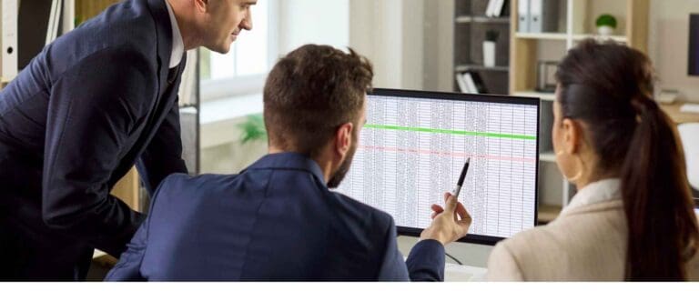 Finance team reviewing spreadsheets and performing a mid-year finance process optimization
